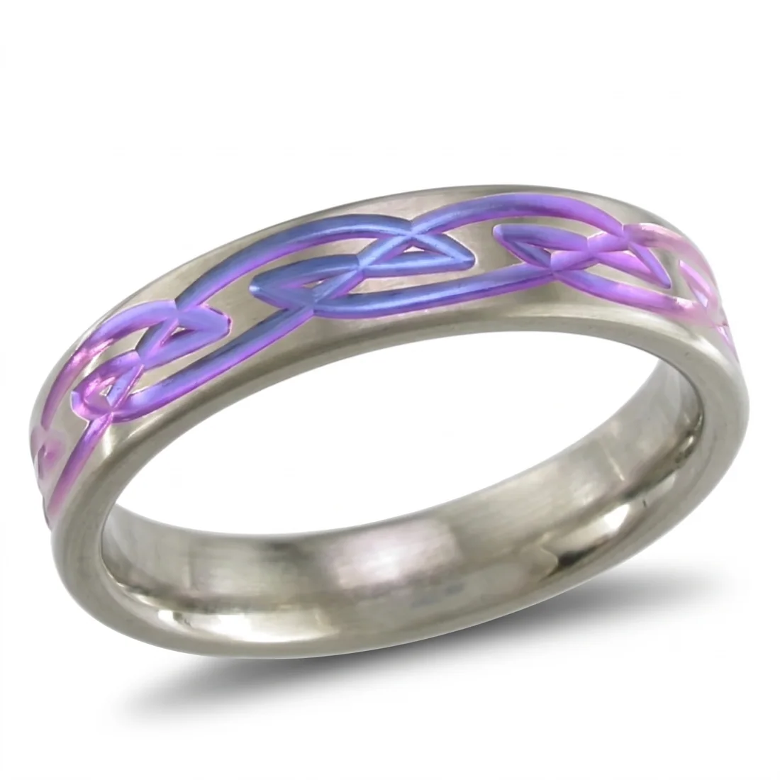 Celtic, anodised, Celtic knotwork, cut into the band and then coloured.