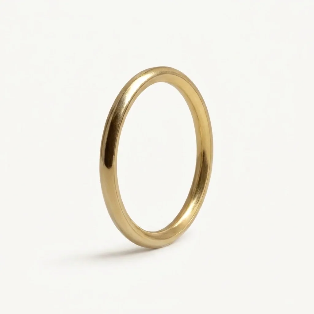 Slim band, Two millimetres of solid gold, narrow enough to sit close to an engagement ring.